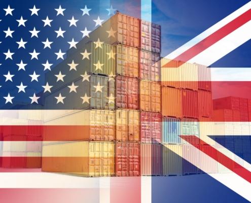 Cargo shipping containers with the American flag in the background