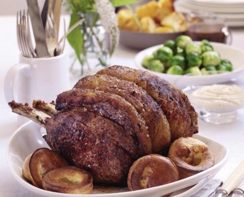 traditional Christmas dinner of roast prime rib of beef and mini Yorkshire puddings
