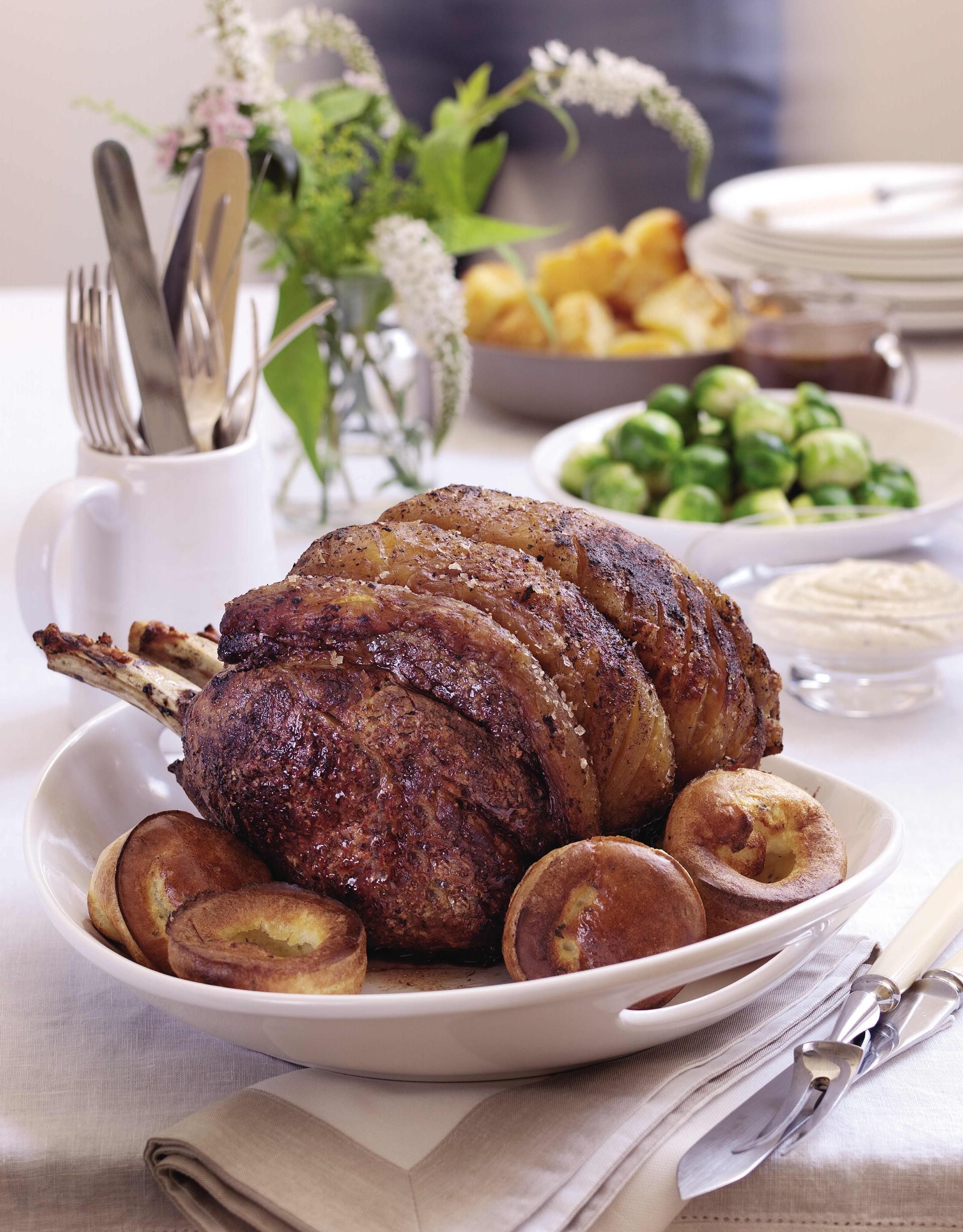 traditional Christmas dinner of roast prime rib of beef and mini Yorkshire puddings