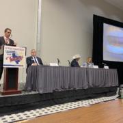 speaker panel at a cattle industry convention in Texas